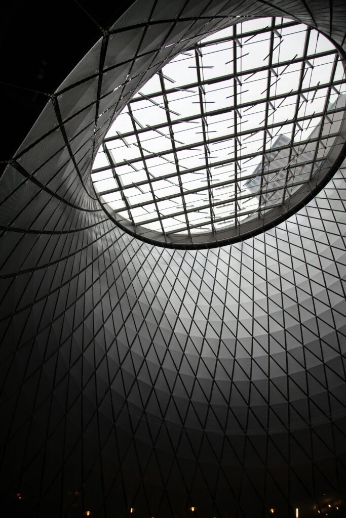 Intricate architectural ceiling with geometric patterns and skylight in New York, capturing modern design.